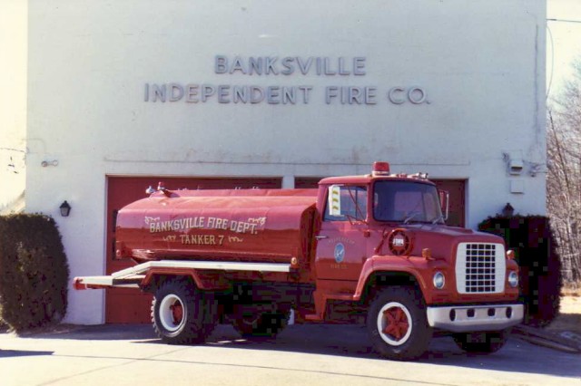 Tanker 7 (retired).  Our first tanker was a converted septic truck.  Cleaned (and cleaned again), painted and refurbished by members, Tanker 7 served from 1980 to 1989,